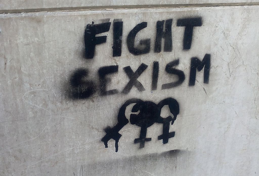 Photo of graffiti on concrete wall reading "Fight Sexism"