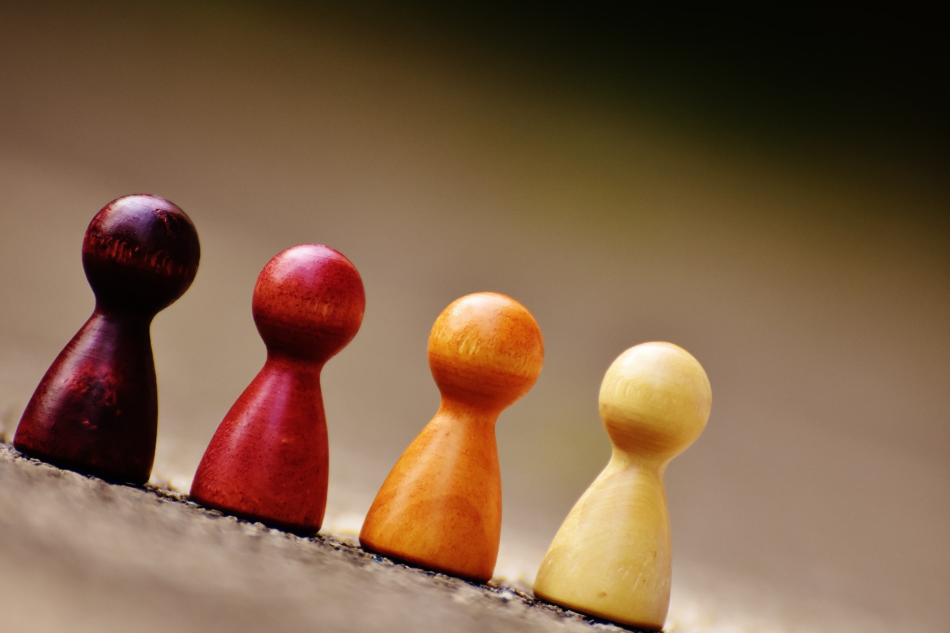 Photograph of board game pieces lined up in a row like little people