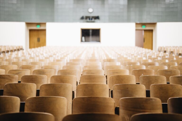 Row after row of empty chairs in a lecture hall.