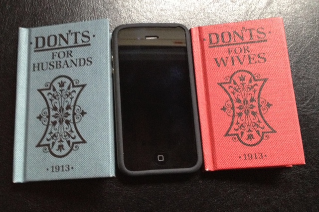 two small copies of the books "Dont's" for Husbands and Wives lay beside an iPhone for comparison, showing that the two small marriage manuals are the size of an iPhone