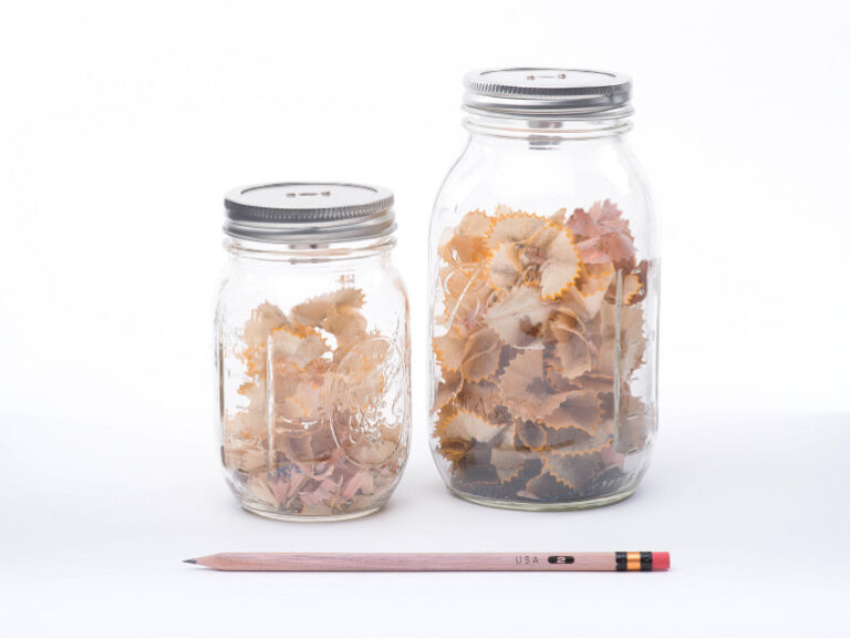 two glass jars containing pencil shavings