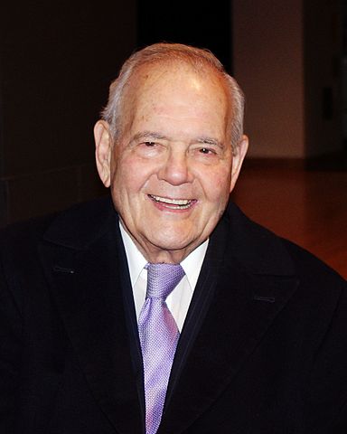 portrait of Robert B Silvers who poses and smiles for the picture