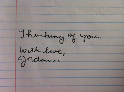 lined paper with the words hand written in cursive: "Thinking of you. With love, Jordan xx"