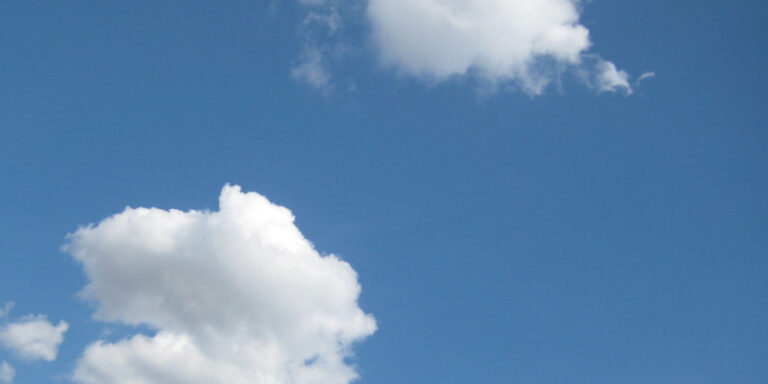 photograph of a bright blue sky with fluffy white clouds