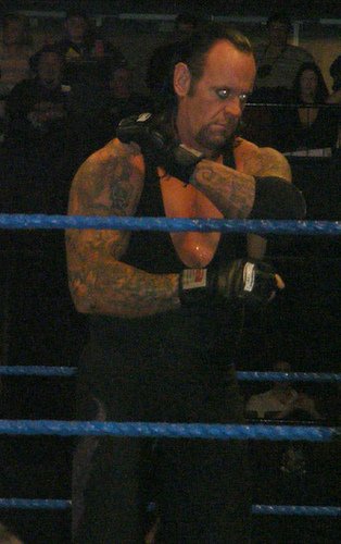 The Undertaker preps for a signature Tombstone Piledriver.