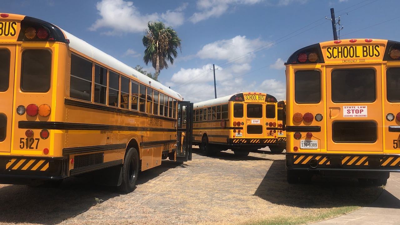 A parking lot of school buses.