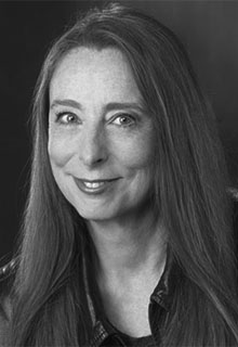 A black and white image of guest a white woman smiling