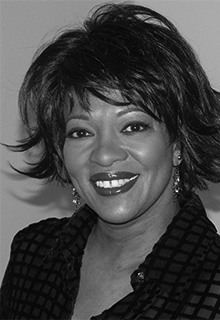 A black and white image of a black woman smiling