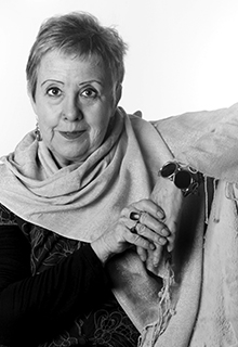 A black and white image of a white woman wearing a large scarf