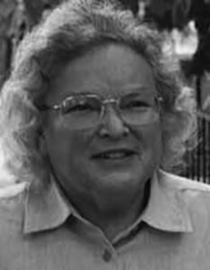 A black and white image of a white woman smiling