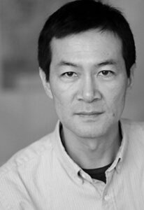 A black and white image of an asian man