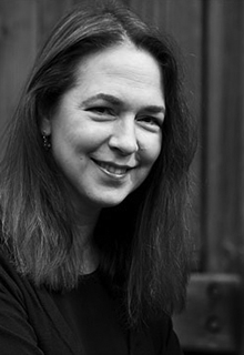 A black and white image of a white woman smiling