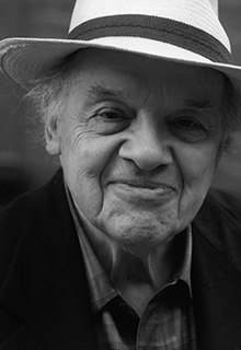 A black and white image of a white man smiling