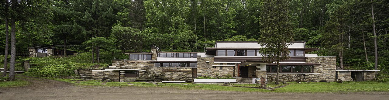 a modern, bricked building in the woods