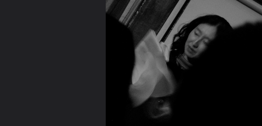 Black and white, blurry picture of an Asian woman. 