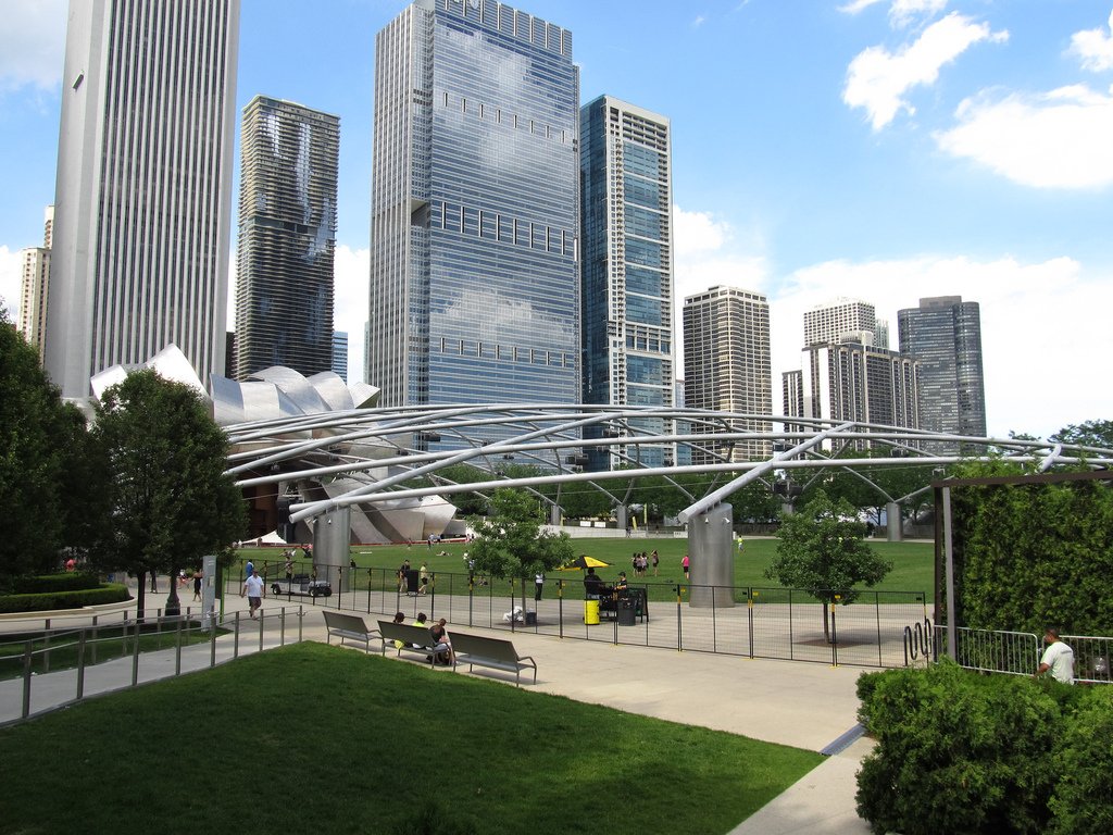 a city park with some trees and buildings in the background. 