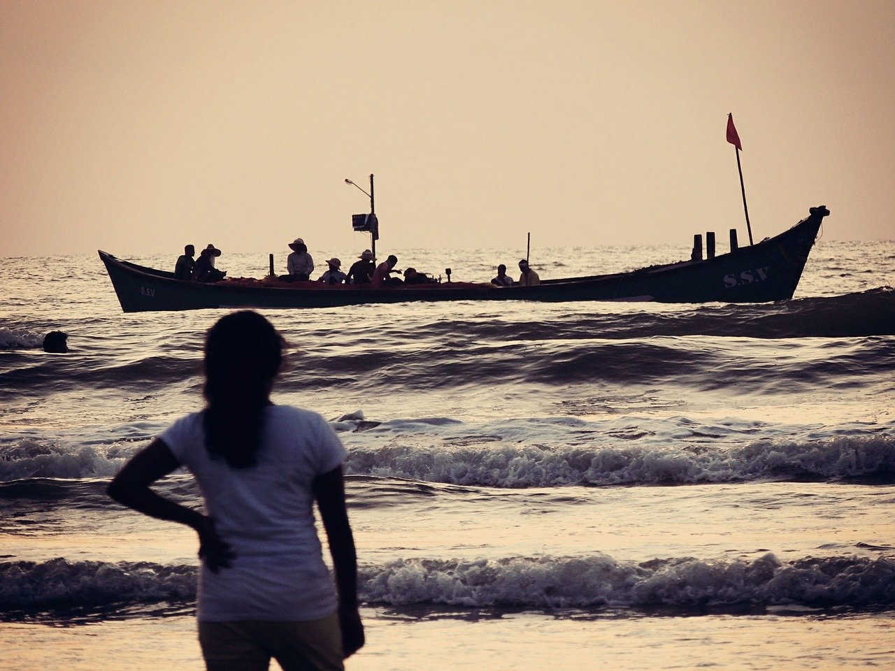 a group of people on a small boat near the shore