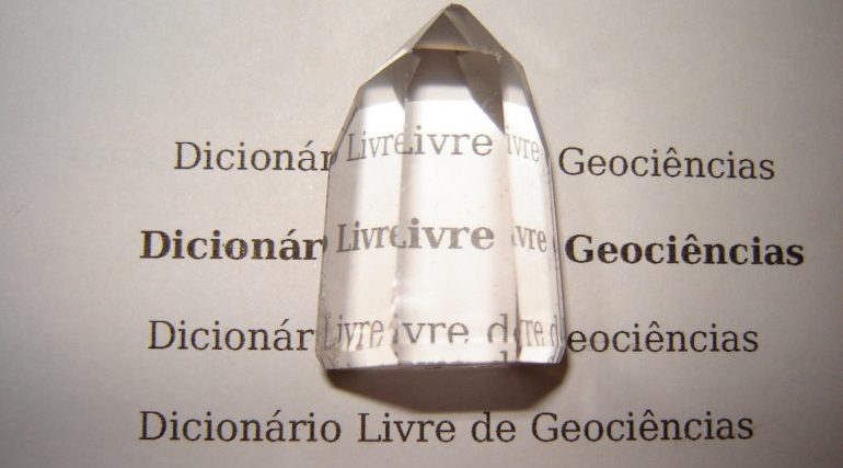 Picture of a crystal on top of a dictionary page on a foreign language