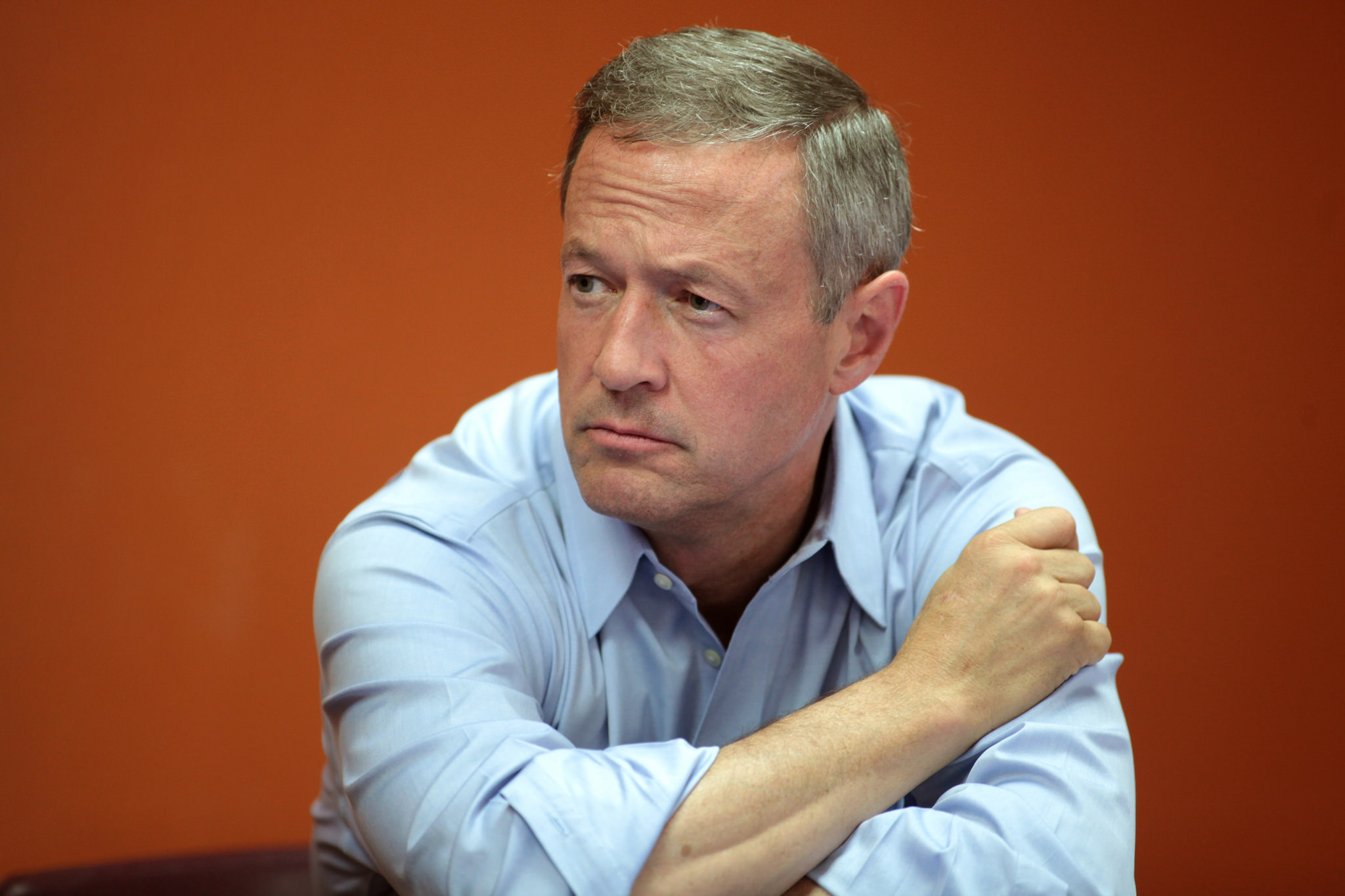 Picture of Martin O'Malley sitting down against an orange background