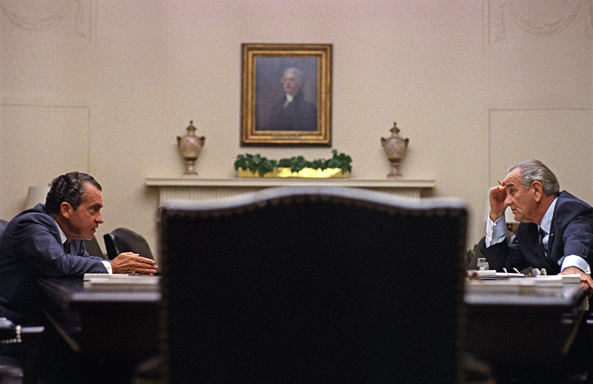 Picture of Nixon & Johnson talking to each other across the table