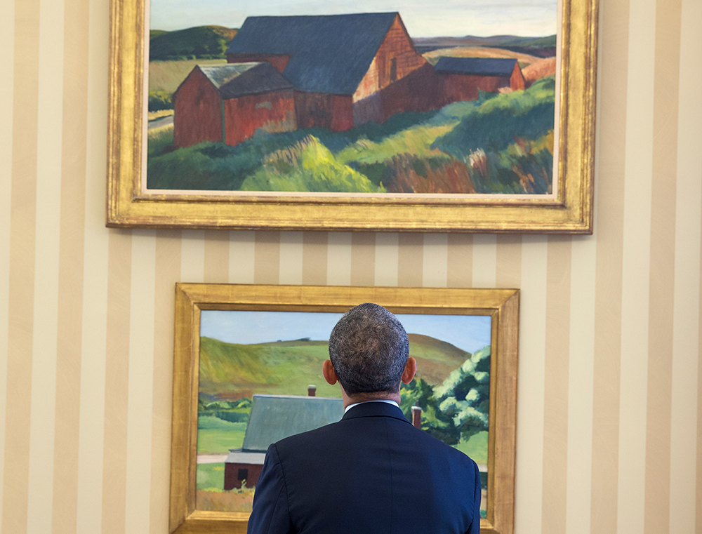 Picture of Barack Obama looking at two Edward Hopper paintings.