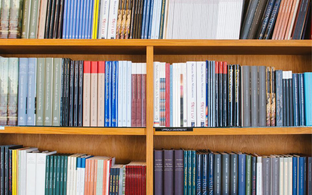 Bookshelf showing book spines of various sizes and colors.