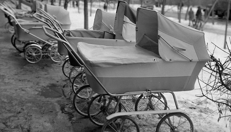 line of old-fashioned baby carriages