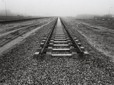 Black and white photograph of broken train tracks.