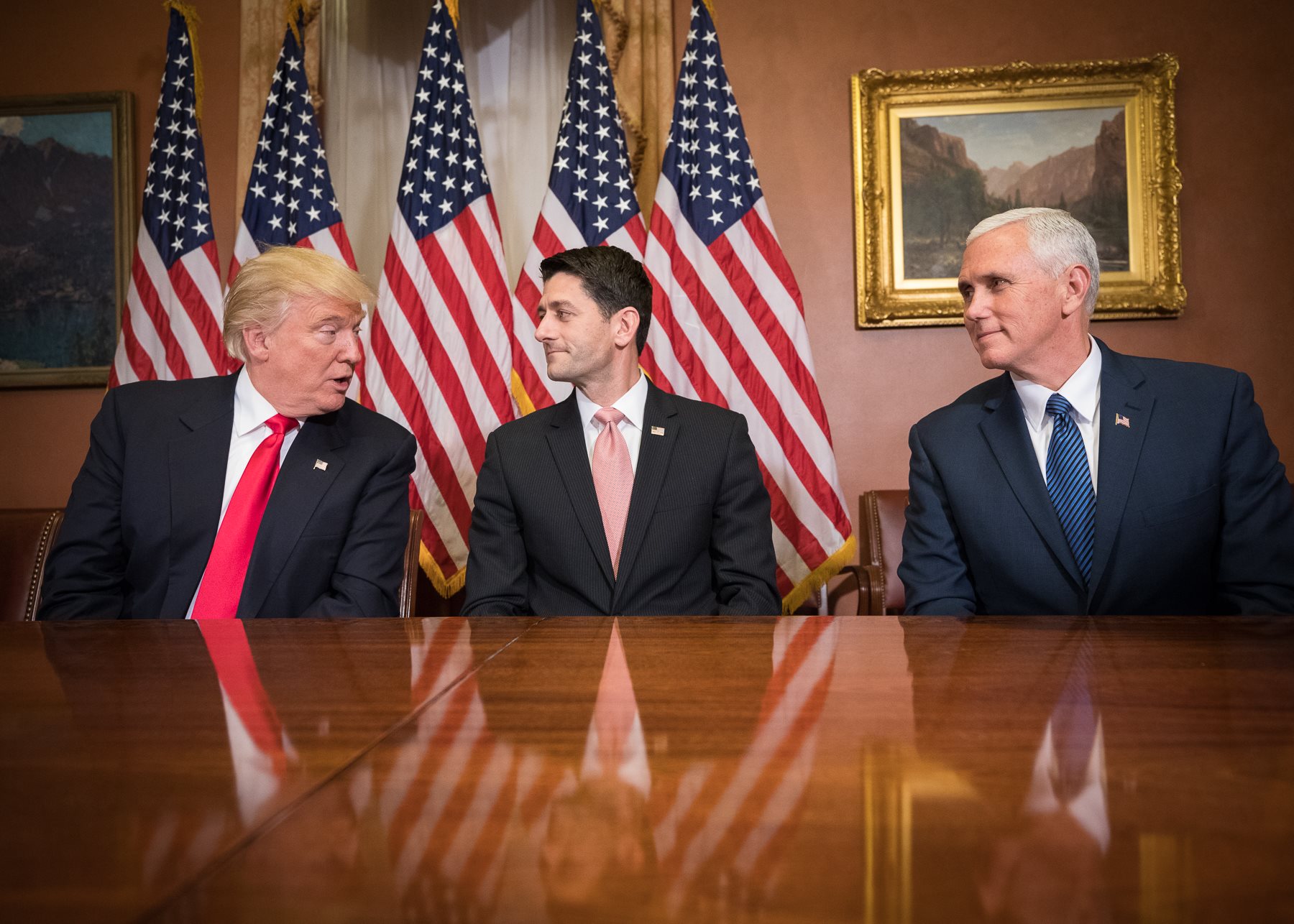 Donald Trump, Paul Ryan, and Mike Pence sitting at a table.