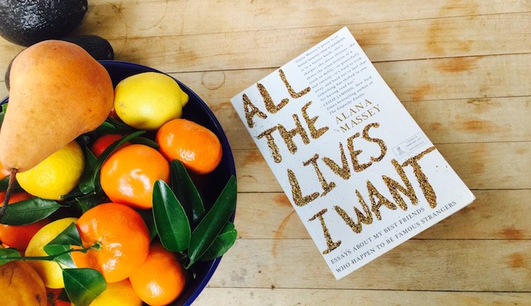 "All the Lives I Want" book next to a bowl of fruit.