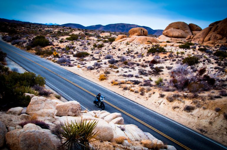 motorcycle riding through desert road