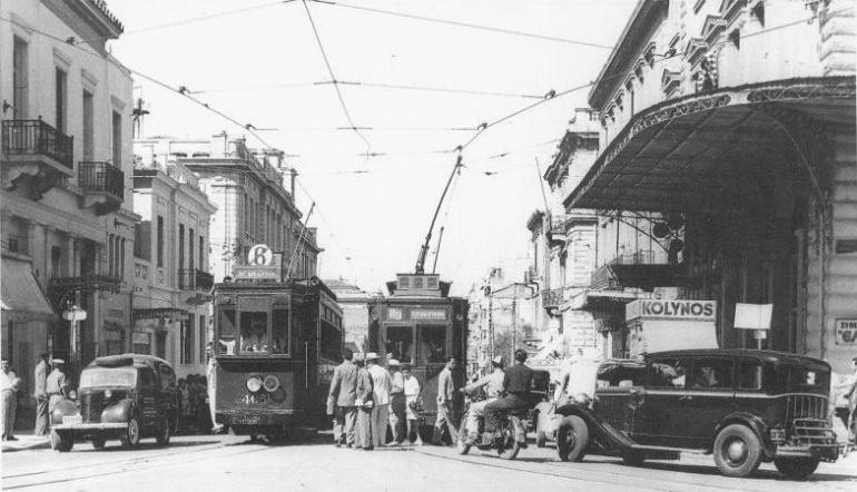 Old photo of people boarding a trolley.