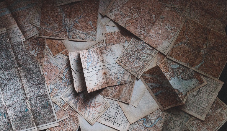 Maps spread out in a pile.