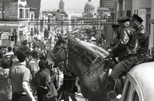 Police riding horses into a crowd.