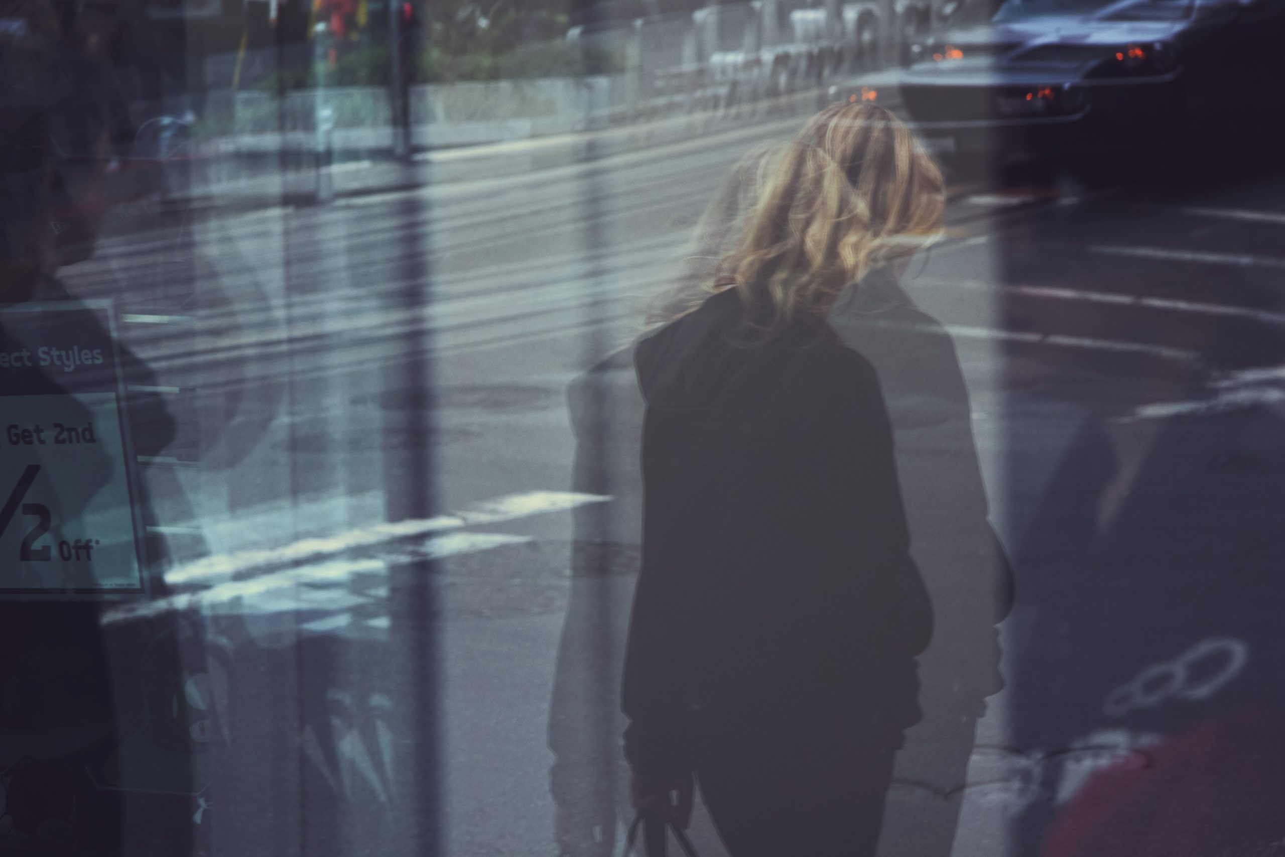 Blurred photograph of a woman walking.