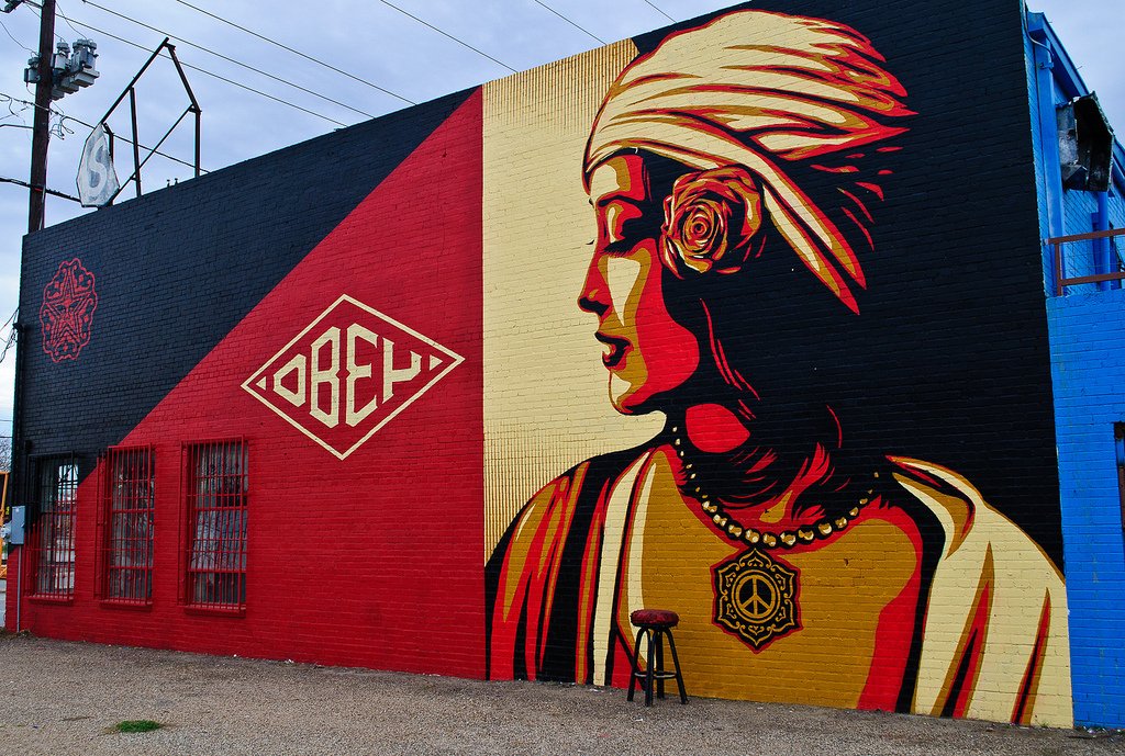 side of building with a painted woman