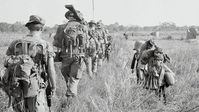 soldiers walking in field 