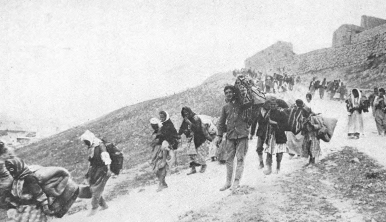 old black and white photo of people walking on trail 