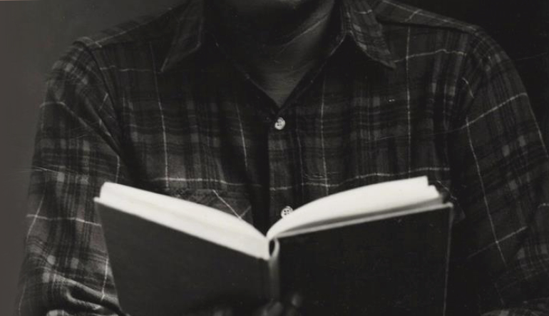 Closeup of man holding a book