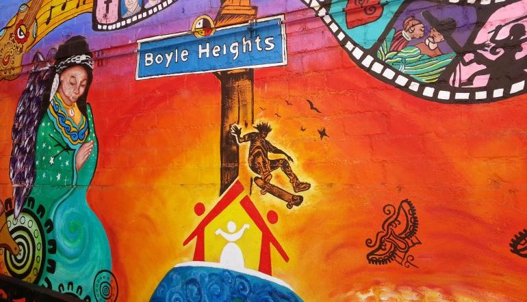 colorful mural with street sign that says Boyle Heights
