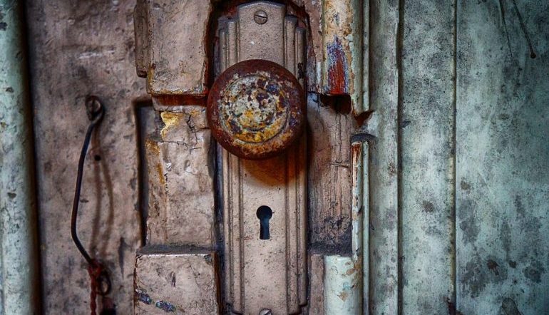 old doorknob crusted in color, a keyhole underneath