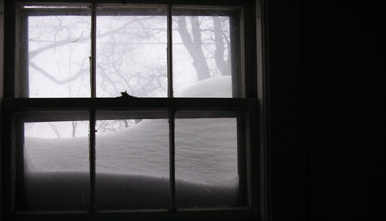 window in a dark room, looking out to a snowy exterior