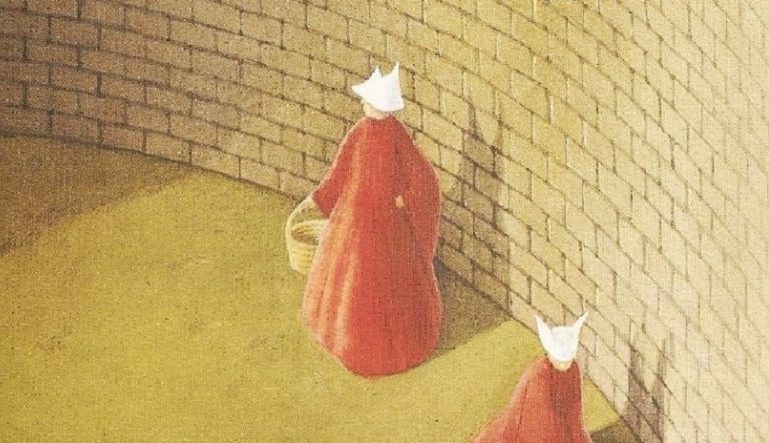 part of The Handmaid's Tale book cover, a drawing of two women in red cloaks and white hats walking in front of a brick wall