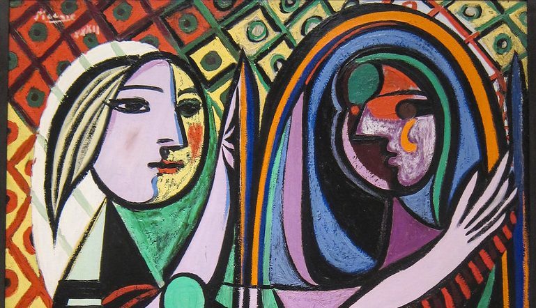 colorful, abstract Picasso painting of a woman in front of a mirror