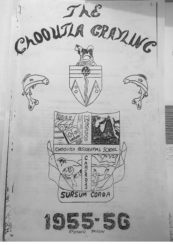 Front cover of The Chooutla Grayling school newspaper. Hand drawn and lettered with a crest. Text says "The Chooutla Grayling 1955-56" and "Raymond Jackson" is hand-written below it. The crest says "MSCC Carcross, Chooutla Residential School, Sursum Corda.