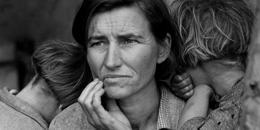Black and white photo of a mother looking concerned for her children.