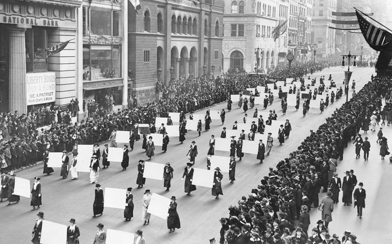 Suffragists parade.