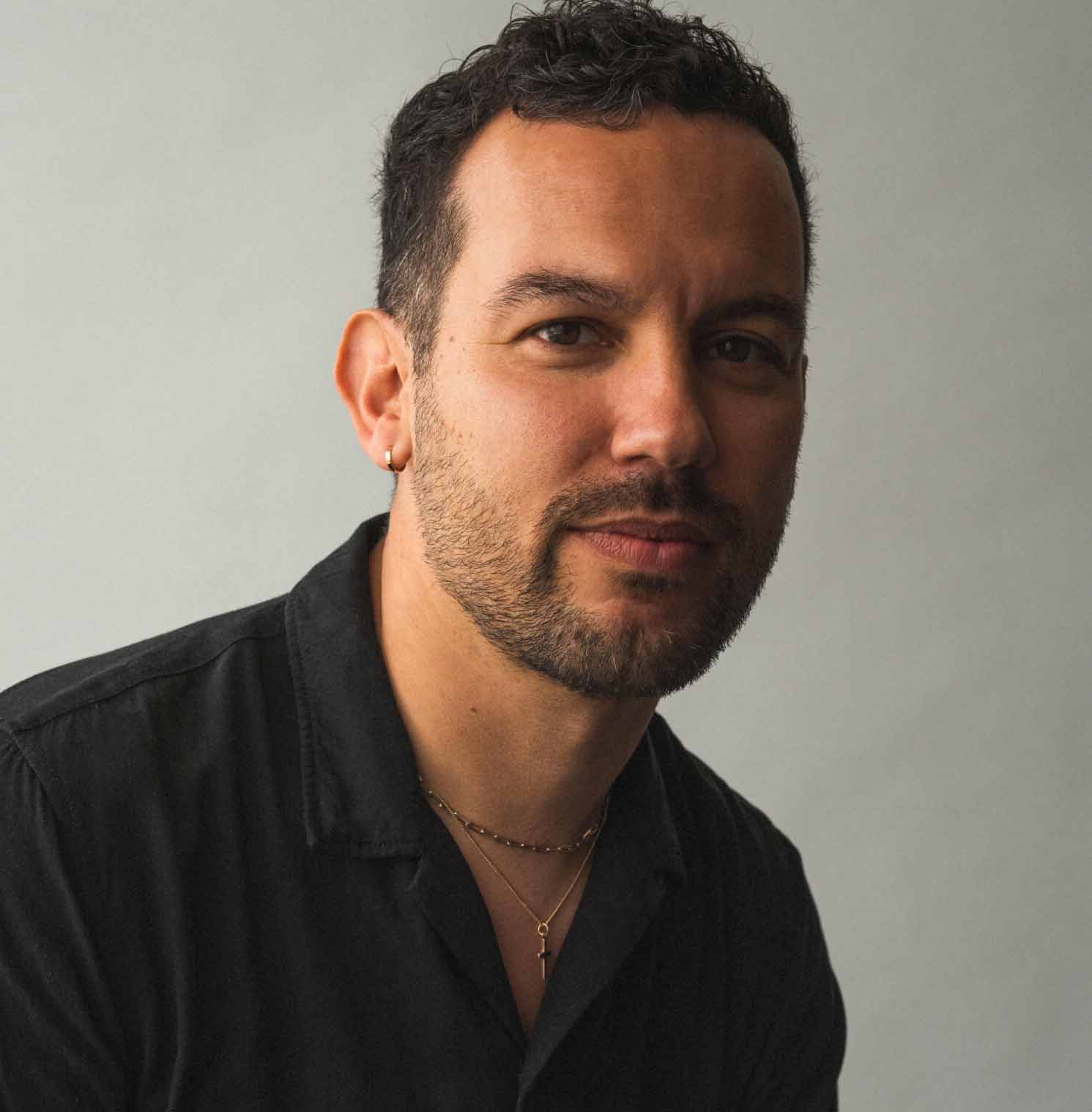 Headshot of guest editor Justin Torres in a black shirt.